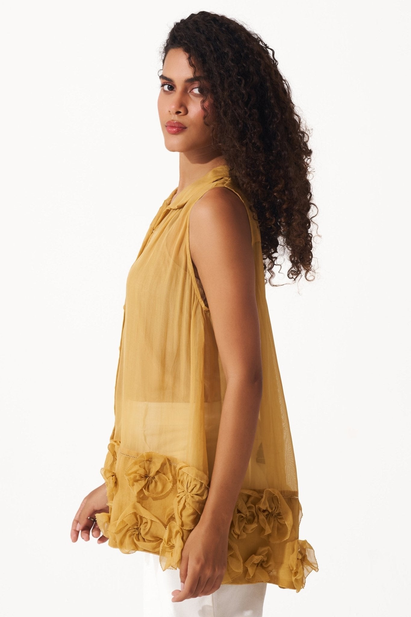 Stylera yellow organza sleeveless shirt with floral detailing on hem worn by model
