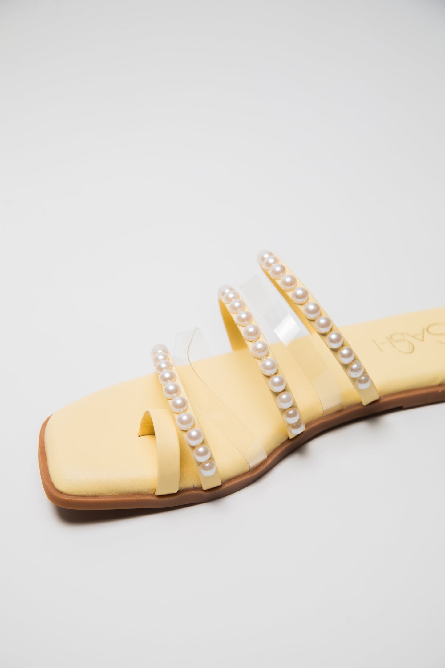 Yellow pearl sandals for women by Stylera with clear straps and pearl embellishments