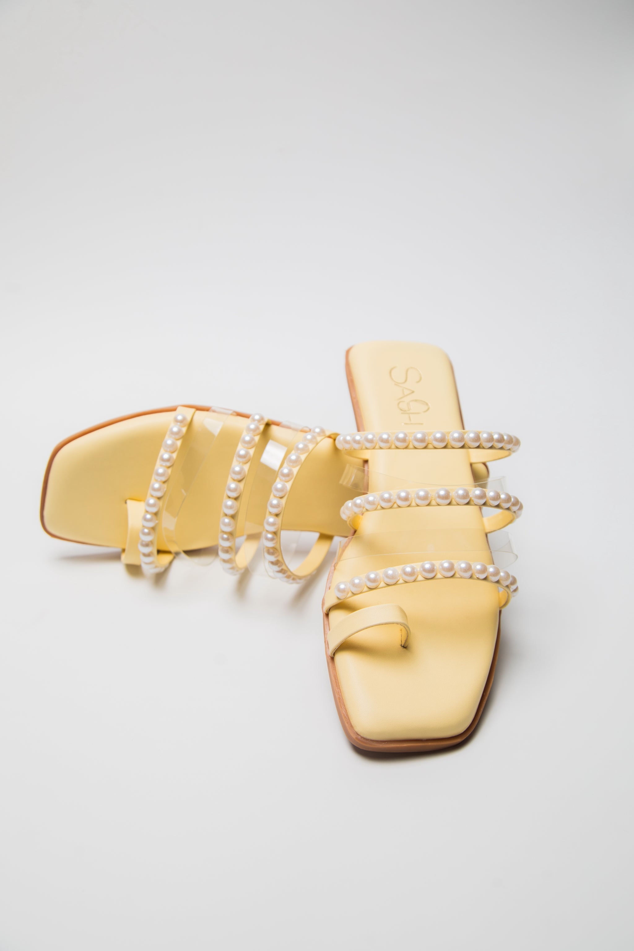 Yellow pearl sandals for women by Stylera featuring pearl-embellished straps and square toe flats