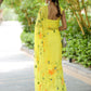 Elegant yellow saree with floral print, showcasing delicate designs and a flowing silhouette