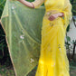 Model wearing a yellow sunflower saree with floral embroidery, showcasing elegance and style.