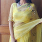 Model wearing a yellow sunflower saree with elegant floral embroidery showcasing a traditional style