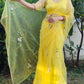 Model showcasing a yellow sunflower saree with floral embroidery and a flowing dupatta outdoors