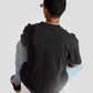 Man wearing black oversized graphic t-shirt from Stylera Lifestyle paired with light blue jeans and black sneakers