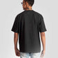 Rear view of a man wearing a black oversized graphic t-shirt with light blue jeans by Stylera Lifestyle