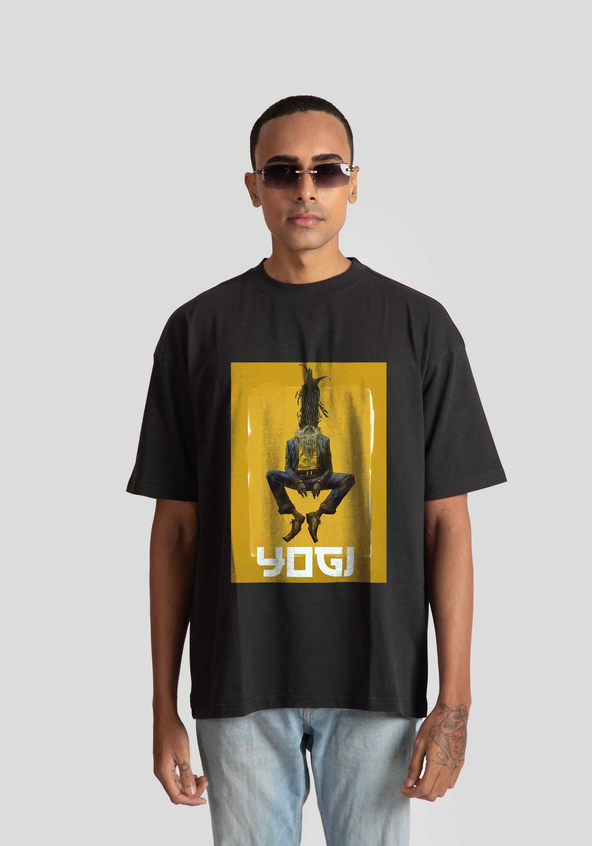 Black oversized graphic t-shirt by Stylera Lifestyle featuring a yellow square with a seated figure print